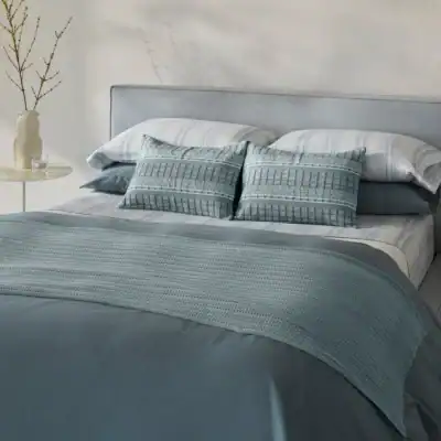 Bed made with organic cotton sheets and duvet in Gulf