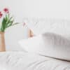 Cotton encased wool pillow in bedroom with fresh flowers.
