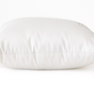 Square wool throw pillow in white cotton encasement against white background