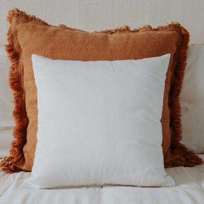 Square wool Euro pillow on a bed.