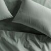 Bed with two pillows and sheets in Cypress green