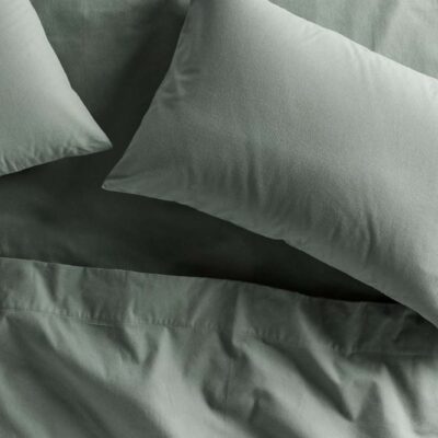 Bed with two pillows and sheets in Cypress green