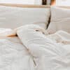 White cotton encased wool comforter on bed in brightly lit bedroom