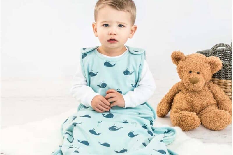 Baby in a Merino Wool Baby Sleep Sack in Light Blue with Whales