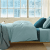 Bedroom with organic cotton percale sheet set in pacific blue