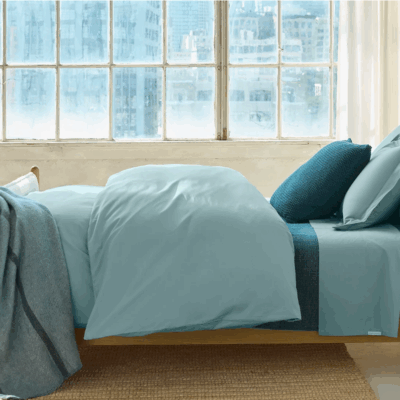 Bedroom with organic cotton percale sheet set in pacific blue