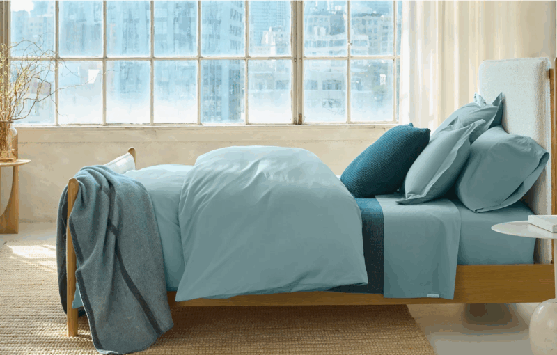 Bedroom with organic cotton percale sheet set in pacific blue