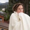 Woman wearing soft Shepherd's Dream Merino Wool Blanket
