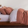 Organic bedroom with sedona reddish brown sheets and duvet