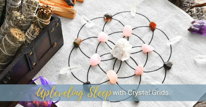 A geometric shape made with interested circles has crystals positioned on the intersections of the lines, with a box of sage and palo Santo incenses nearby.