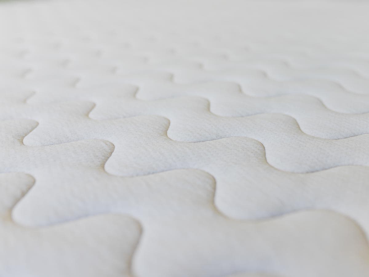 Detail image of wavy stitching on organic cotton mattress cover.