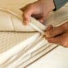 Person unzipping natural latex mattress