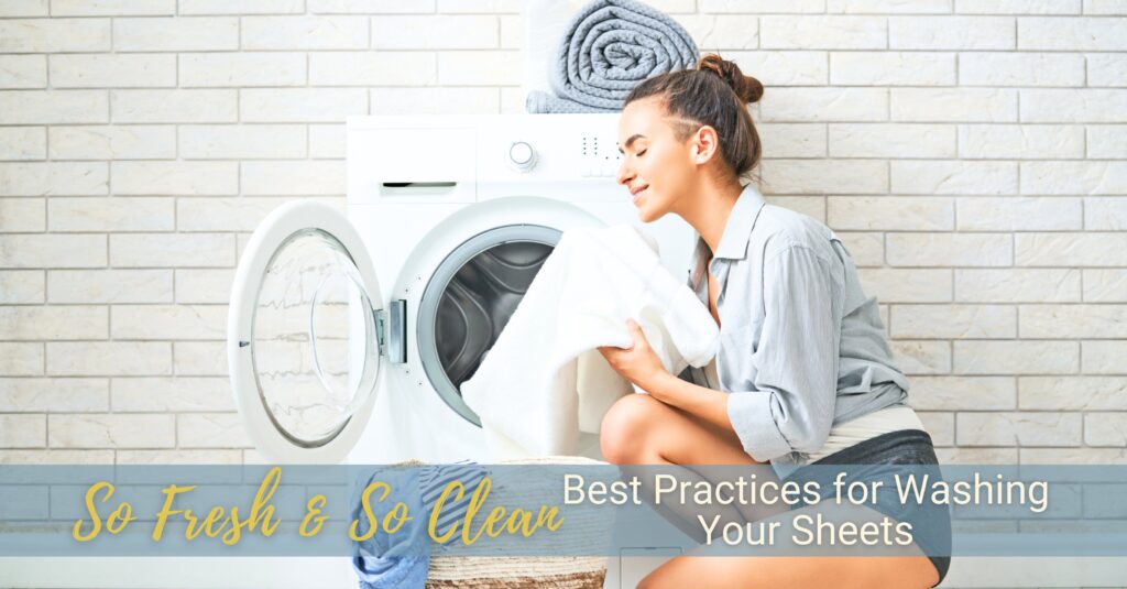 A young woman kneels in front of a laundry drying machine, breathing in the fresh scent of clean laundry.