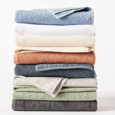 Stack of organic cotton Air Weight towels in various colors