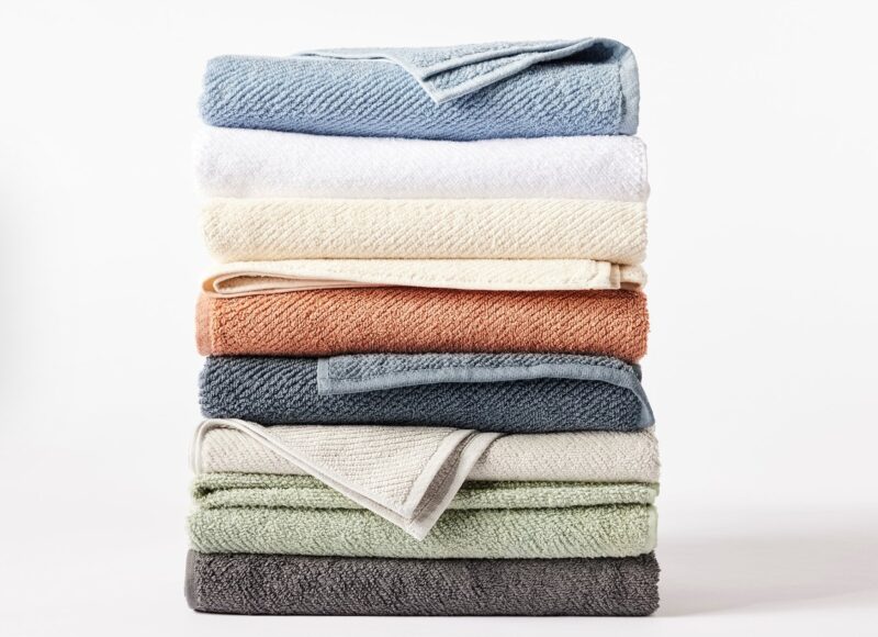 Stack of organic cotton Air Weight towels in various colors