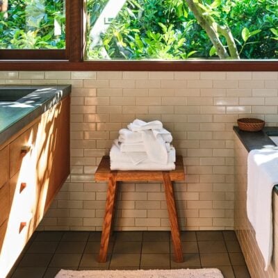 Bathroom with organic cotton towels on wooden pedestal